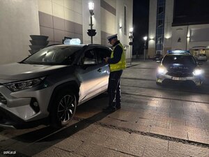 policjant przy samochodzie osobowym